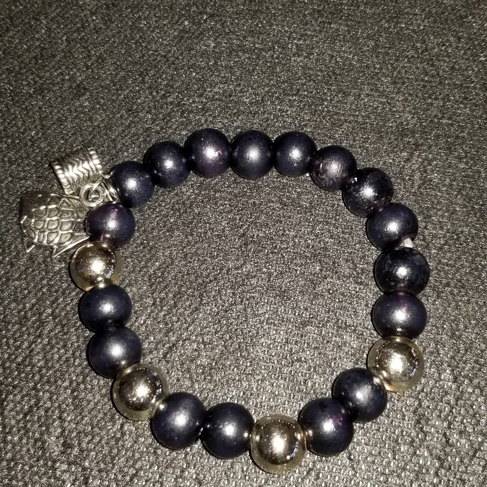 Silver and black bracelet with two silver charms.